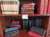 Full bookshelf with vintage and leatherbound hardcover books in various colors and sizes