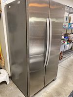 Front view of stainless steel side-by-side refrigerator with doors closed