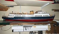 Full side view of the wooden model boat showing its hull, superstructure, and details.