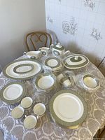 Full tabletop arrangement showing all plates, bowls, cups and serving pieces