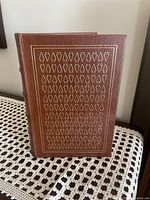 Front cover of the leather bound book with gold embossed geometric patterns.