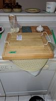 Wooden cutting boards stacked on kitchen counter with place mat underneath