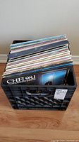 View of 41 LP vinyl records stored upright in a black crate container with one visible album titled CHFI 98.1
