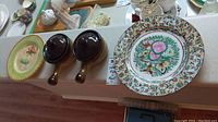 Photo showing the two brown ceramic French onion soup bowls with lids, two ceramic plates with floral, bird and ornate patterns, and two decorated Royal Stafford plates