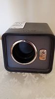 Front view of the black Birks watch winder showing the circular watch holder with chrome trim and Birks logo embossed on top.
