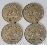 Reverse sides of 4 Canadian 5 cent coins dated 1942 showing the beaver on rock design