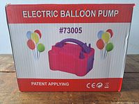 Box labeled 'Electric Balloon Pump' with image of the pink pump and balloon graphics.