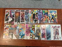 Tabletop with 20 Marvel comics arranged in two rows, eleven are bagged and carded in protective sleeves, the others are loose but in excellent condition.