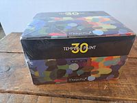 Photo of the Magicfly branded box with colorful pattern and 'Tempera Paint 30' text showing product packaging.