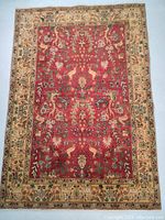 Full view of red field and beige floral border.