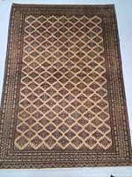 Full view of rug face showing overall diamond lattice design and border.