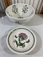 Two white ceramic bowls stacked, showing large inner floral designs and smaller bowl with Sweet William flower and leaf border