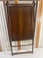 Full view of vintage wooden folding bar cart frame, showing entire frame and lower shelf panel, missing top shelf.