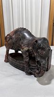 Front and side view of the vintage stone elephant carving showing natural stone patterns and overall shape.