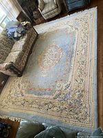 Full view of rug laid on hardwood floor beside sofa and chairs