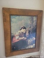 Frontal view of leather framed oil on canvas painting of two girls with basket of fruit, depicting The Little Fruitseller.