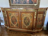Front view of console cabinet showing marquetry panels, gilt bronze mounts, and cracked marble top