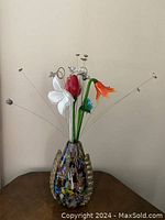 Full view of vase with glass flowers and metal wire accents