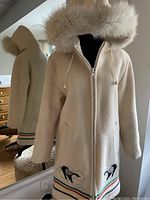 Front view on mannequin showing hood, zipper closure and pocket placement