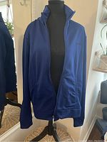 Navy blue Bench jacket displayed on a black mannequin showing full front zipper and side pockets.