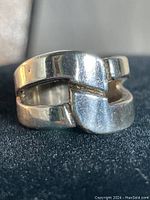Close-up front view of the vintage sterling silver artistic ring with polished finish and open geometric design.