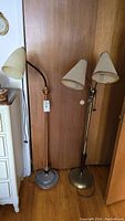 Full view of two floor lamps side by side showing bases and lampshades