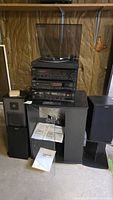 Full stereo system stack on stand with turntable, receiver, CD player, cassette deck, and speakers