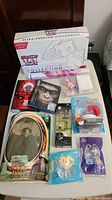 Full lot showing assorted collectibles, DVDs, action figures and Pokemon box