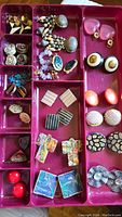Overview of 18 pairs of vintage earrings in red tray organizer including various styles and materials
