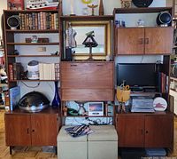 Front view of full three-piece modular wall unit showing left, center, right modules