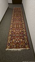 Full length photo of the narrow wool runner rug in a hallway setting