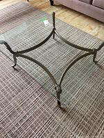 Top view of the iron base showing its curved design and decorative joints on a carpeted floor.