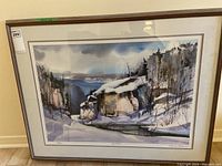 Full view of framed limited edition lithographic print showing a winter landscape with snow, rocks, and distant water.
