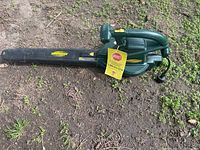 Full side profile of the electric leaf blower showing the cord and handle.