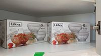 Two unopened boxes of Libbey Frost storage bowls with lids showing front packaging with images of glass bowls containing food.