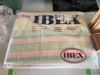 Full view of packaged IBEX flannel blanket showing brand, size, and materials