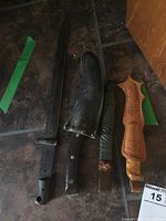 Four cutters laid out on the floor showing size and sheath conditions