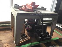 Photo showing full router table setup with mounted router and accessories underneath