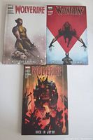 Three hardcover Wolverine comic books laid out showing front covers: Wolverine's Revenge, Wolverine vs The X-Men, Wolverine Back in Japan.