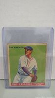 Front view of 1933 Ray Kremer baseball card in protective sleeve showing full illustration and text.