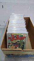 Box of bagged and boarded comics in cardboard box