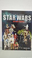 Front cover of The Ultimate Guide to Vintage Star Wars Action Figures 1977-1985 showing various Star Wars action figures.