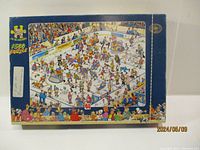 Box showing the puzzle image depicting a busy ice hockey rink with many characters and details, the image displays the assembled puzzle artwork that the completed puzzle would form.