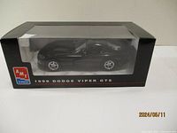 Side view of the 1999 Dodge Viper GTS die cast model car inside clear display box with AMT ERTL branding and black packaging.