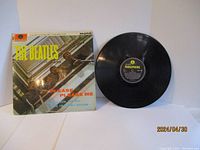Front cover with visible wear and vinyl record beside it, showing overall lot condition.