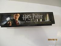 Box of the Harry Potter wand, showing branding and image of Harry Potter holding wand