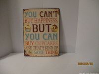 Photo of metal sign with colorful text and cupcake/pie illustrations