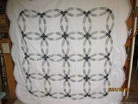 Full view of the spread quilt showing the full double wedding ring pattern.