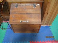 Top front view of the vintage pine storage box with closed hinged lid and metal handles