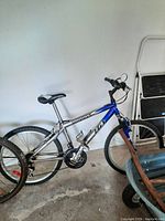 Silver and blue Wings LG mountain bike with 22" frame, visible front and rear wheel, knobby tires, and handlebar setup.